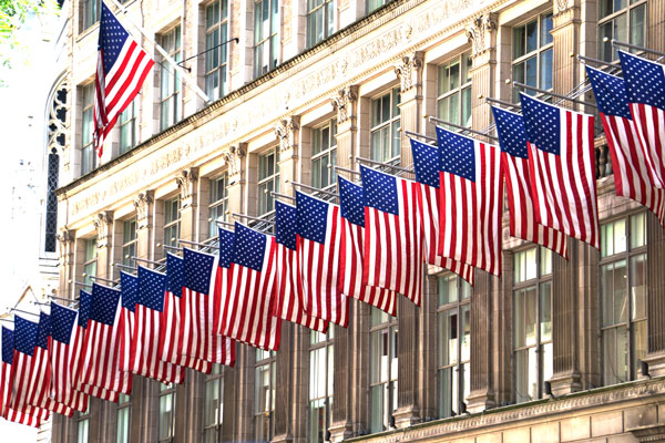 American flags hanging across Fifth Avenue store windows